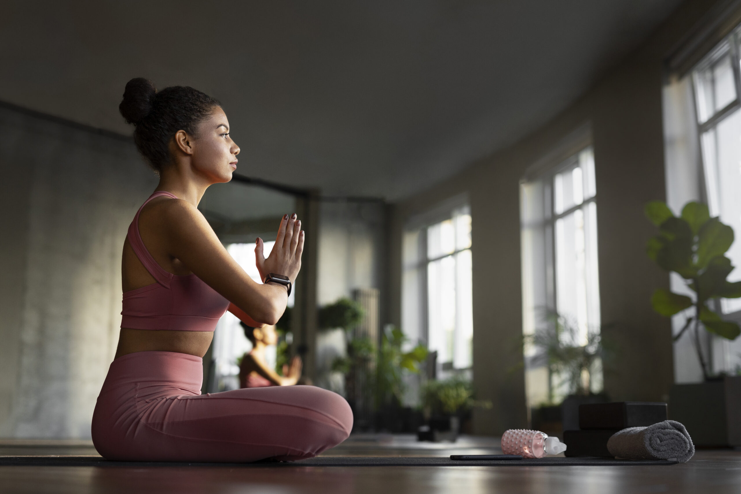 Sporty young woman doing yoga practice isolated on white background. Concept of healthy life and natural balance between body and mental development