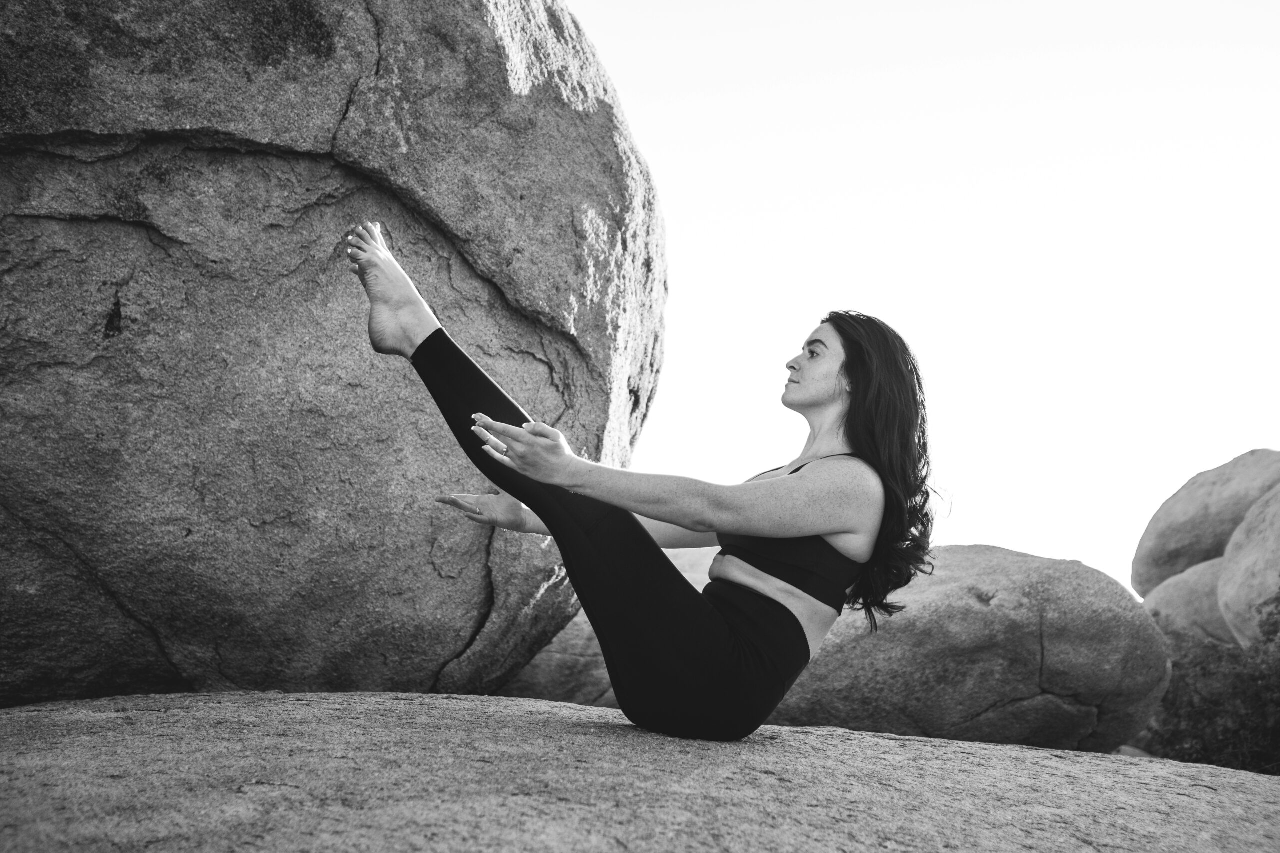 Sporty young woman doing yoga practice isolated on white background. Concept of healthy life and natural balance between body and mental development